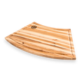 Curved striped wood cutting board with juice groove on a white background